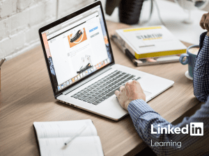 Someone looking at a laptop and doing work. Logo of LinkedIn Learning beside it.