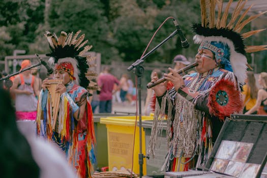 Native American musicians performing outdoors in traditional wear with woodwind instruments.
